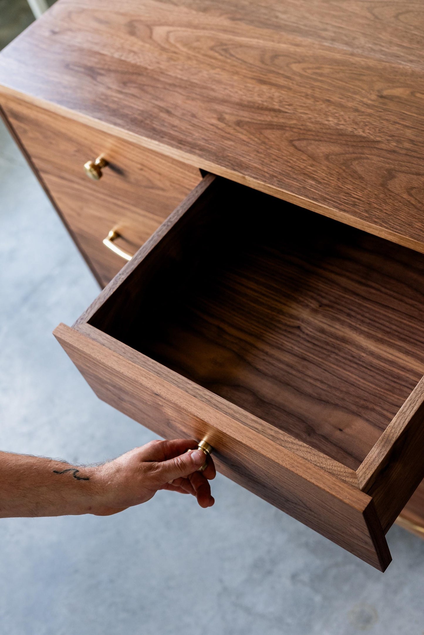 The “Levine Dresser”, Mid Century Modern Hardwood Dresser with a Gallery Rail & Hand Cut Joinery. Fully Customizable Sizing and Drawers.